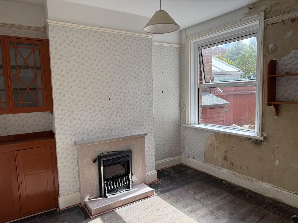 Lot: 38 - THREE-BEDROOM HOUSE IN NEED OF IMPROVEMENT - Dining room with fireplace